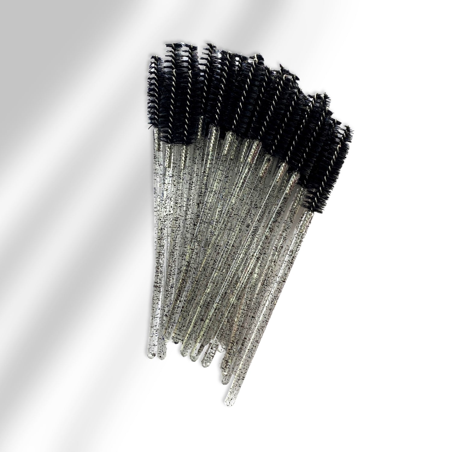 A stack of black and clear glittered spoolies with black bristle head. 