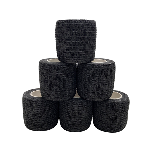 Six rolls of black grip tape staked on top of each other in a tier. 