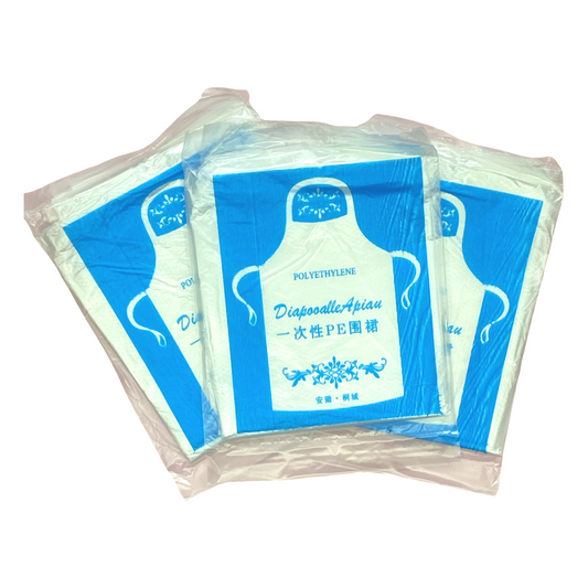 Three Packets of a clear disposable apron laying flat just overlapping each other.